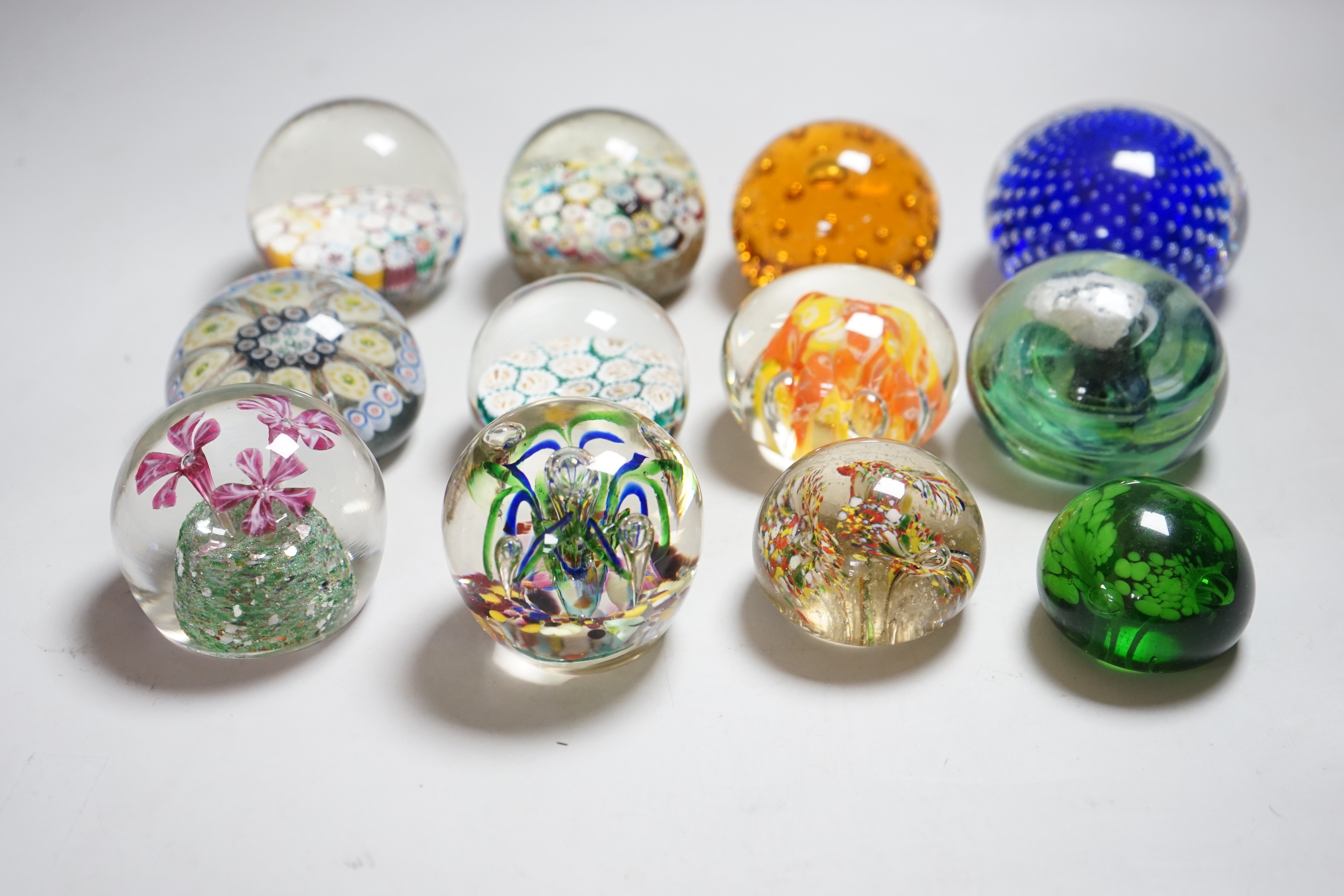 Twelve 20th century paperweights including Bohemian and Chinese examples, close packed millefleur canes, lamp work, etc.